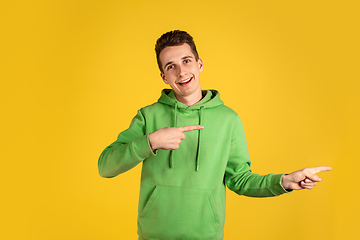 Image showing Portrait of young caucasian man isolated on yellow studio background