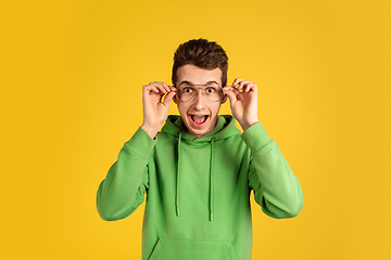 Image showing Portrait of young caucasian man isolated on yellow studio background