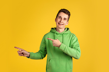 Image showing Portrait of young caucasian man isolated on yellow studio background