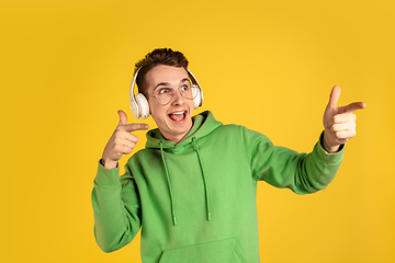 Image showing Portrait of young caucasian man isolated on yellow studio background