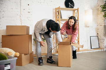 Image showing New property owners, young couple moving to new home, apartment, look happy