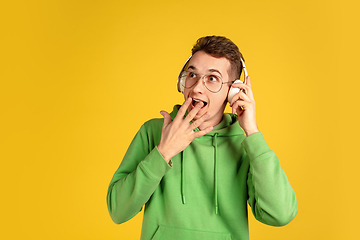 Image showing Portrait of young caucasian man isolated on yellow studio background