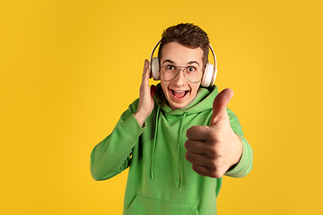 Image showing Portrait of young caucasian man isolated on yellow studio background