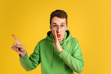 Image showing Portrait of young caucasian man isolated on yellow studio background