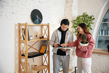 Image showing New property owners, young couple moving to new home, apartment, look happy