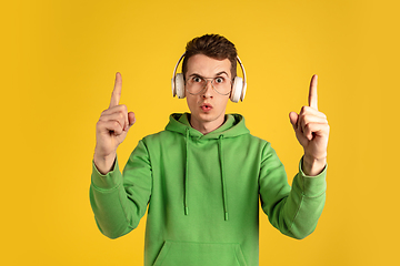 Image showing Portrait of young caucasian man isolated on yellow studio background