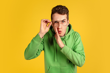 Image showing Portrait of young caucasian man isolated on yellow studio background