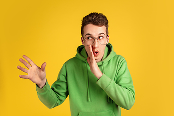 Image showing Portrait of young caucasian man isolated on yellow studio background