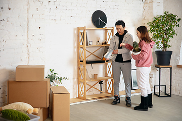 Image showing New property owners, young couple moving to new home, apartment, look happy