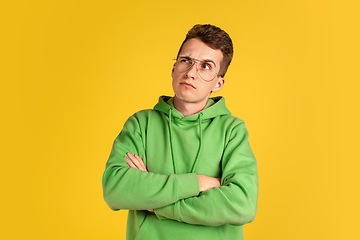 Image showing Portrait of young caucasian man isolated on yellow studio background