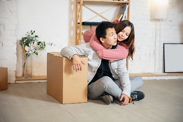 Image showing New property owners, young couple moving to new home, apartment, look happy