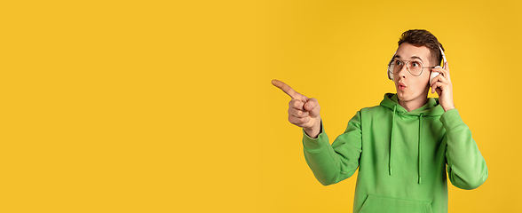 Image showing Portrait of young caucasian man isolated on yellow studio background