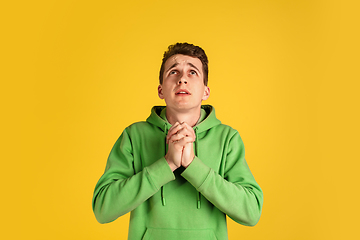 Image showing Portrait of young caucasian man isolated on yellow studio background