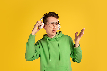 Image showing Portrait of young caucasian man isolated on yellow studio background