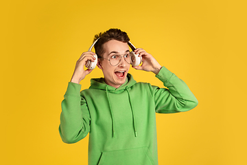 Image showing Portrait of young caucasian man isolated on yellow studio background