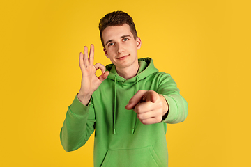 Image showing Portrait of young caucasian man isolated on yellow studio background