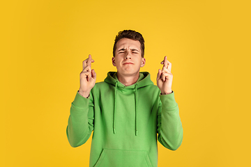 Image showing Portrait of young caucasian man isolated on yellow studio background