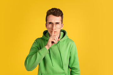 Image showing Portrait of young caucasian man isolated on yellow studio background