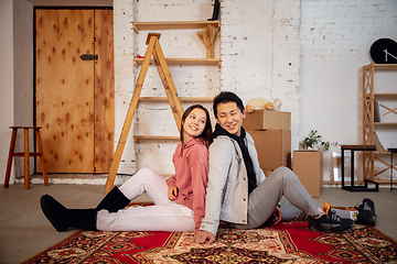 Image showing New property owners, young couple moving to new home, apartment, look happy