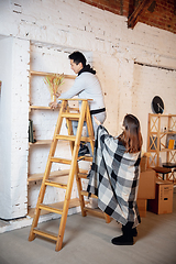 Image showing New property owners, young couple moving to new home, apartment, look happy