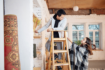 Image showing New property owners, young couple moving to new home, apartment, look happy