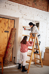 Image showing New property owners, young couple moving to new home, apartment, look happy