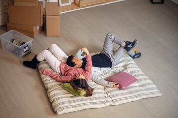 Image showing New property owners, young couple moving to new home, apartment, look happy