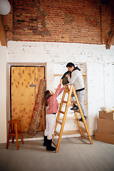 Image showing New property owners, young couple moving to new home, apartment, look happy