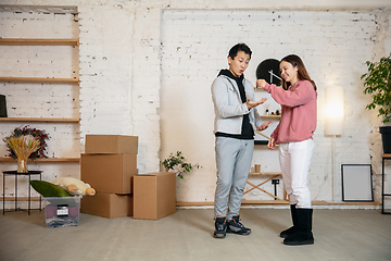 Image showing New property owners, young couple moving to new home, apartment, look happy