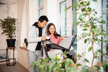 Image showing New property owners, young couple moving to new home, apartment, look happy