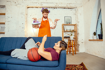 Image showing Gender stereotypes. Wife and husband doing things unusual for their genders in social meanings