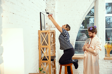 Image showing Gender stereotypes. Wife and husband doing things unusual for their genders in social meanings