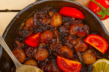 Image showing Baby cuttle fish roasted on iron skillet