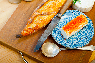 Image showing French cheese and fresh  baguette on a wood cutter