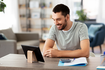 Image showing man with tablet pc working at home office