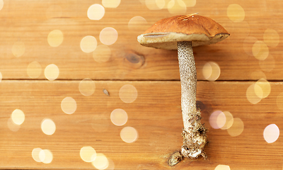 Image showing brown cap boletus mushrooms on wooden background