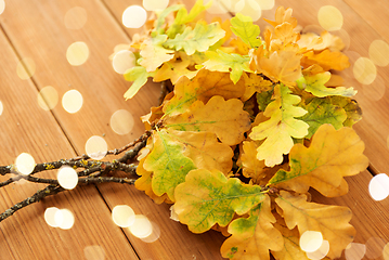 Image showing oak leaves in autumn colors on wooden table