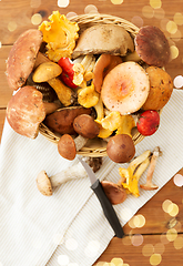 Image showing basket of different edible mushrooms and knife