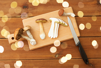 Image showing edible mushrooms, kitchen knife and cutting board