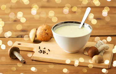 Image showing mushroom cream soup in bowl on cutting board