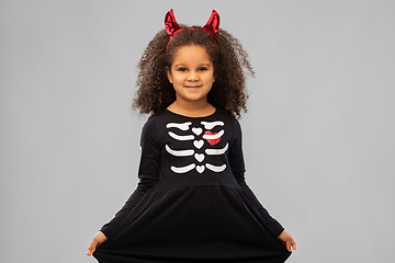 Image showing girl in black dress and devil's horns on halloween