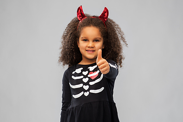 Image showing girl in black dress and devil's horns on halloween