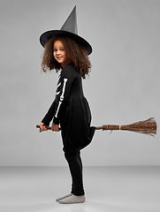 Image showing girl in black witch hat with broom on halloween