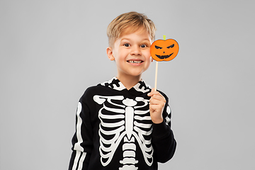 Image showing happy boy in halloween costume with jack-o-lantern