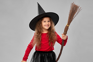 Image showing girl in black witch hat with broom on halloween