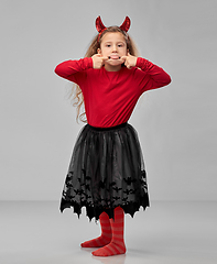 Image showing girl in halloween devil's costume making faces