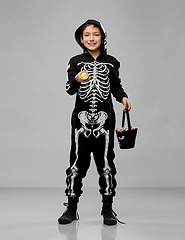 Image showing boy with candies and flashlight on halloween