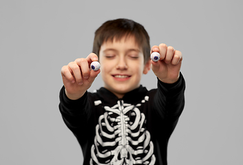 Image showing boy in halloween costume with eyeball candies