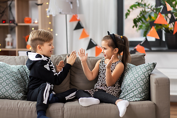 Image showing kids in halloween costumes playing game at home