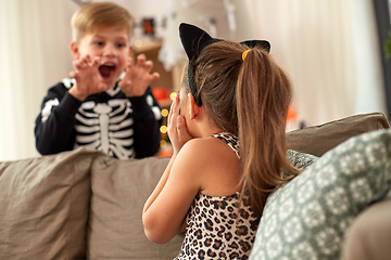 Image showing kids in halloween costumes having fun at home